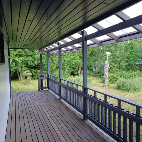 a wooden deck with a pergola on a house at Villa Finlandia, Tornio at the border of Finland and Sweden in Tornio