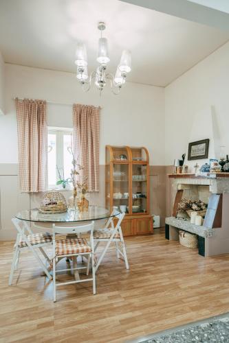 a dining room with a glass table and chairs at Vintage Beach House in Matosinhos