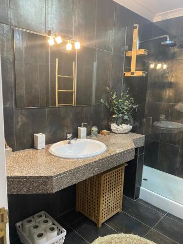 a bathroom with a sink and a mirror at Soltroia Dunas House in Troia
