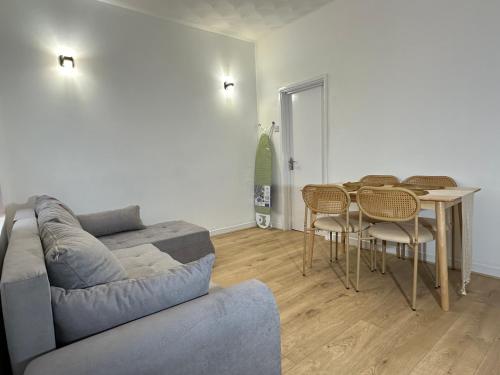 a living room with a couch and a table at Large double room in Portsmouth - Mayhall Rd in Portsmouth