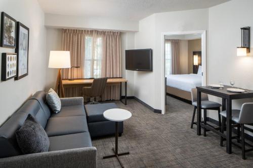 a hotel room with a couch and a bed at Residence Inn by Marriott Cape Canaveral Cocoa Beach in Cape Canaveral