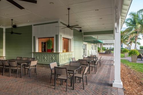 a row of tables and chairs on a patio at Residence Inn by Marriott Cape Canaveral Cocoa Beach in Cape Canaveral