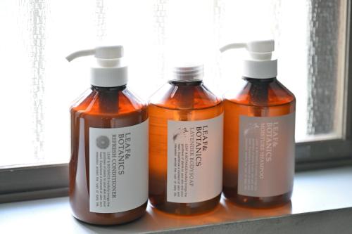 three bottles of honey sitting on a shelf at わとなみ in Tonosho
