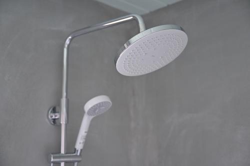 a shower with a shower head in a bathroom at わとなみ in Tonosho