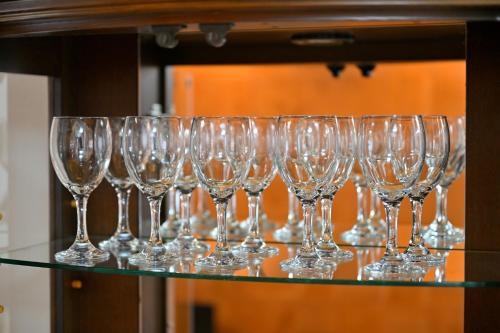 a row of wine glasses sitting on a glass shelf at わとなみ in Tonosho