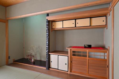 a room with a closet with a bunk bed at わとなみ in Tonosho