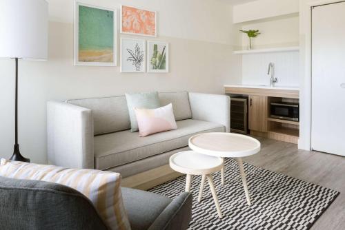 a living room with a couch and a table at Hampton by Hilton Grand Cayman Seven Mile Beach in George Town