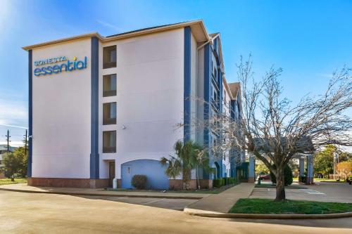 a building with a sign on the side of it at Sonesta Essential NW Houston in Houston