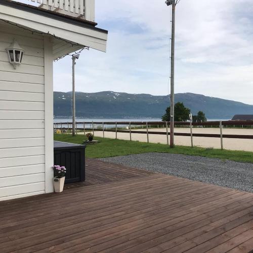 a porch of a house with a view of the water at Marisletta farm - house by the sea in Tromsø