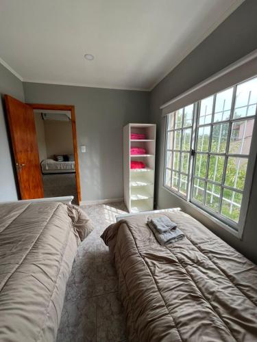 a bedroom with a bed and a large window at Alquiler Temporario Ruta 3 Depto 2 in Azul