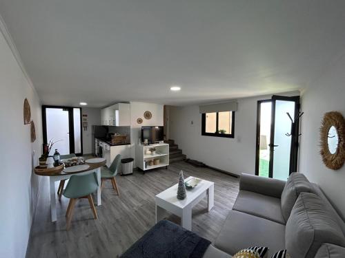 a living room with a couch and a table at Funchal Casa in Funchal