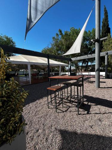 a picnic table in a park with a white canopy at Hostal de Los Andes in Rodeo de la Cruz