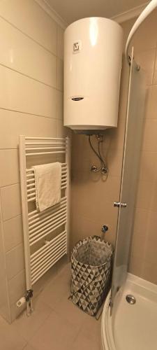 a bathroom with a toilet and a sink and a towel at City apartman Modrica in Modriča