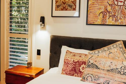 a bedroom with a bed with two pillows and a table at Narrows Escape Rainforest Retreat in Montville
