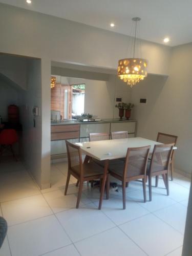 a kitchen and dining room with a table and chairs at Apartamento próximo do aeroporto de João Pessoa e das principais praias in Bayeux
