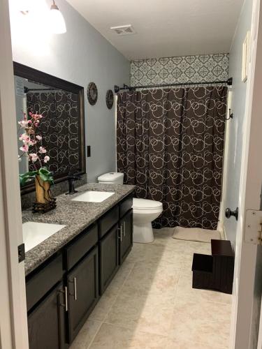a bathroom with two sinks and a toilet and a shower at 777 Hopi in Buckeye