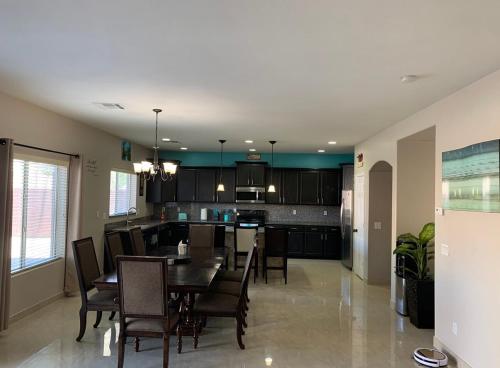 a dining room and kitchen with a table and chairs at 777 Hopi in Buckeye
