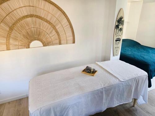 a bedroom with a bed and a blue couch at Studio Qu'importe, Jardin, Jacuzzi, Massage in Bandol