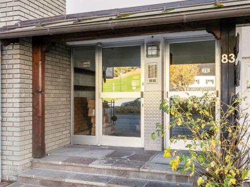 a front door of a house with windows at Brixen Alpin Living Top 1 und 2 und 3 in Brixen im Thale