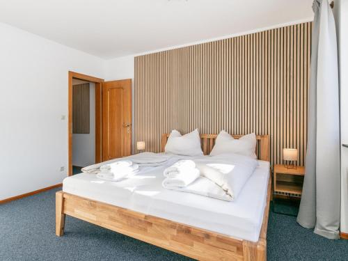 a bedroom with a bed with white towels on it at Brixen Alpin Living Top 1 und 2 und 3 in Brixen im Thale