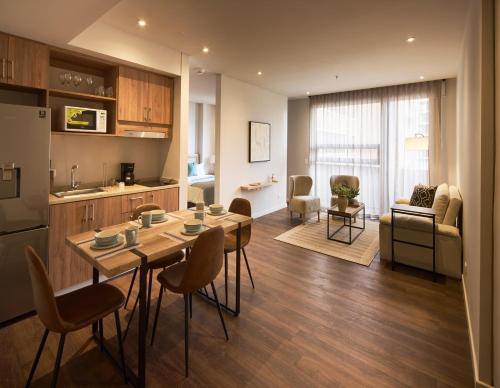 a kitchen and living room with a table and chairs at Caluce Apt 3D by Letoh in Chía