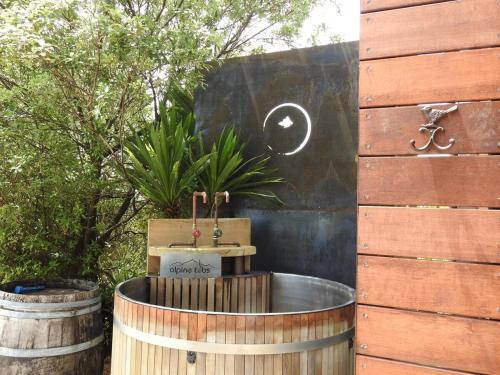 a wooden barrel with a fountain in a garden at The Lookout- Clevedon in Clevedon