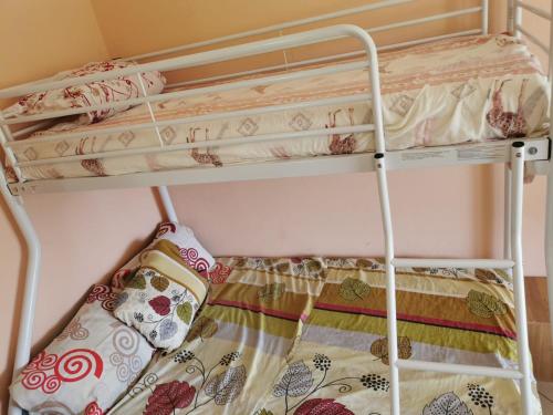 a bunk bed in a room with two bunk beds at Chambres d'hôte dans la charmante commune de Ste Rose in Sainte-Rose
