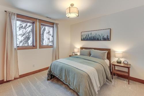 a bedroom with a bed and two windows at Ski-InandSki-Out Schweitzer Mtn Home Decks and Views! in Sandpoint