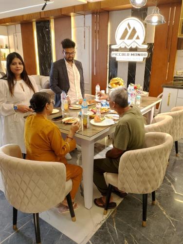 a group of people sitting around a table eating at Piccolo Mondo Boutique Hotel in Cairo