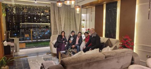 a group of people sitting on a couch in a living room at Piccolo Mondo Boutique Hotel in Cairo