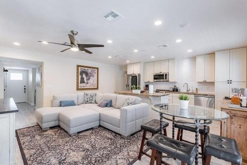 a living room with a couch and a table at 4-bedroom house in Gilbert - Remodeled Retreat in Gilbert