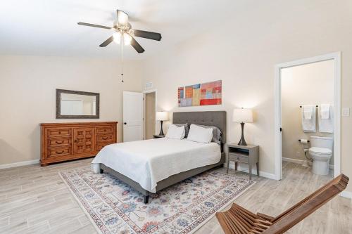 a bedroom with a bed and a ceiling fan at 4-bedroom house in Gilbert - Remodeled Retreat in Gilbert