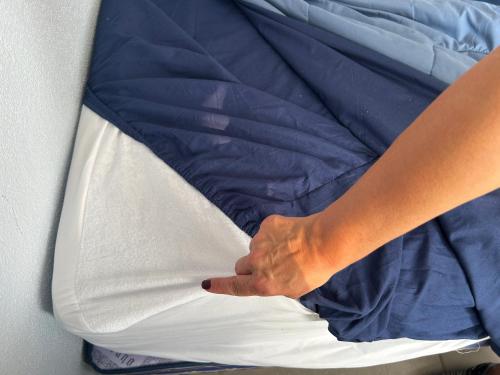 a persons hand is on top of a bed at New Modern Acapulco Diamante House Getaway with Pool View and Beach Club in Acapulco