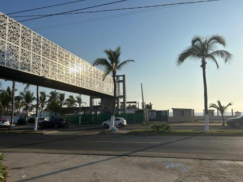 a parking lot with palm trees and a building at New Modern Acapulco Diamante House Getaway with Pool View and Beach Club in Acapulco