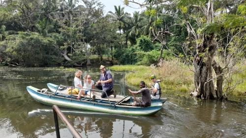 a group of people in a boat on a river at Wild View Stay in Habarana