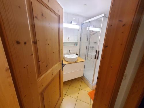 a bathroom with a sink and a shower at Single room in nice house in Klosters Dorf