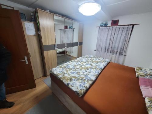 a small bedroom with a bed and a closet at Single room in nice house in Klosters Dorf