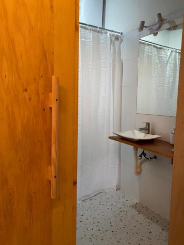 a bathroom with a shower with a sink and a mirror at Mañanitas del Este reserva con seña in Barra del Chuy