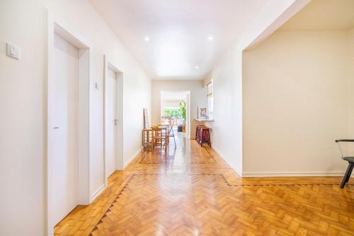 an empty hallway with white walls and wood floors at Big apt 4beds with terrace, 15 mins to Lisbon in Almada
