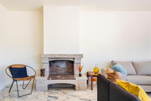 a living room with a fireplace and a couch at Big apt 4beds with terrace, 15 mins to Lisbon in Almada