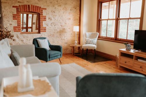 a living room with a couch and chairs and a tv at Cole-Brook New Cottage - McLaren Vale in McLaren Vale