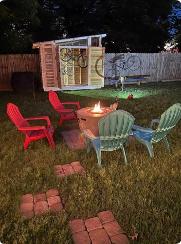 a fire pit in a yard with chairs and a house at Perfectly located 2 bed/2 full bathroom/1 sofa bed in Bentonville