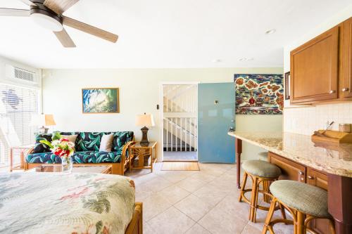 a kitchen and living room with a bed and a couch at Amazing condo peaks of ocean view On Ali'i Dr by surf spots in Kailua-Kona