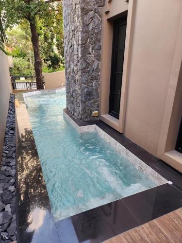 a pool of water in front of a house at T1-Tuscany Private Pool Villa-บางแสน in Ban Hua Khao Sammuk