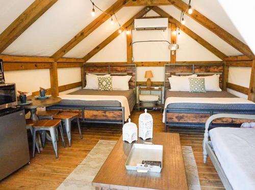a large room with two beds and a table at Safari Cabin A in Seguin
