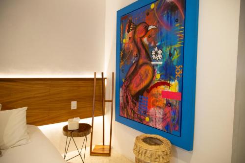 a large painting on the wall of a bedroom at Casa de Arte Hotel Boutique in Oaxaca City