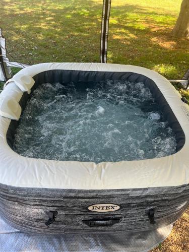 a jacuzzi tub with water in it at Amazing House Hot Tub Mins To Major Hospitals in Middle Valley