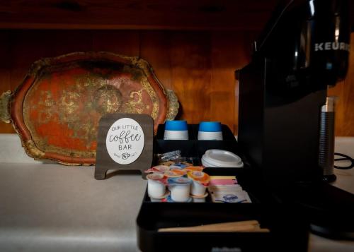 a table with cups and a sign next to a computer at Amazing House Hot Tub Mins To Major Hospitals in Middle Valley