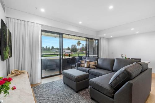 a living room with a couch and a table at Kove Apartments Kiama in Kiama