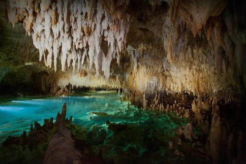 a cave with a pool of water in it at SUITE 2A, BLUE PAVILION - Steps to BEACH in West Bay